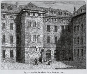 A black and white print of a large stone building. It is four floors and has several windows, all with bars. There are several people standing and walking in front of the building.