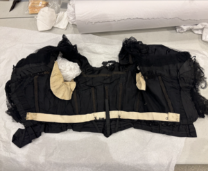 The interior of the bodice. Shows hook and eye enclosure. Boning structure, additionally padding for the armsleeves.