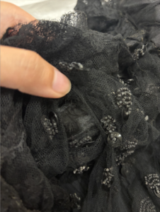 Close up of the possible original neckline where corded detailing is. See bunched up fabric and some pulling.